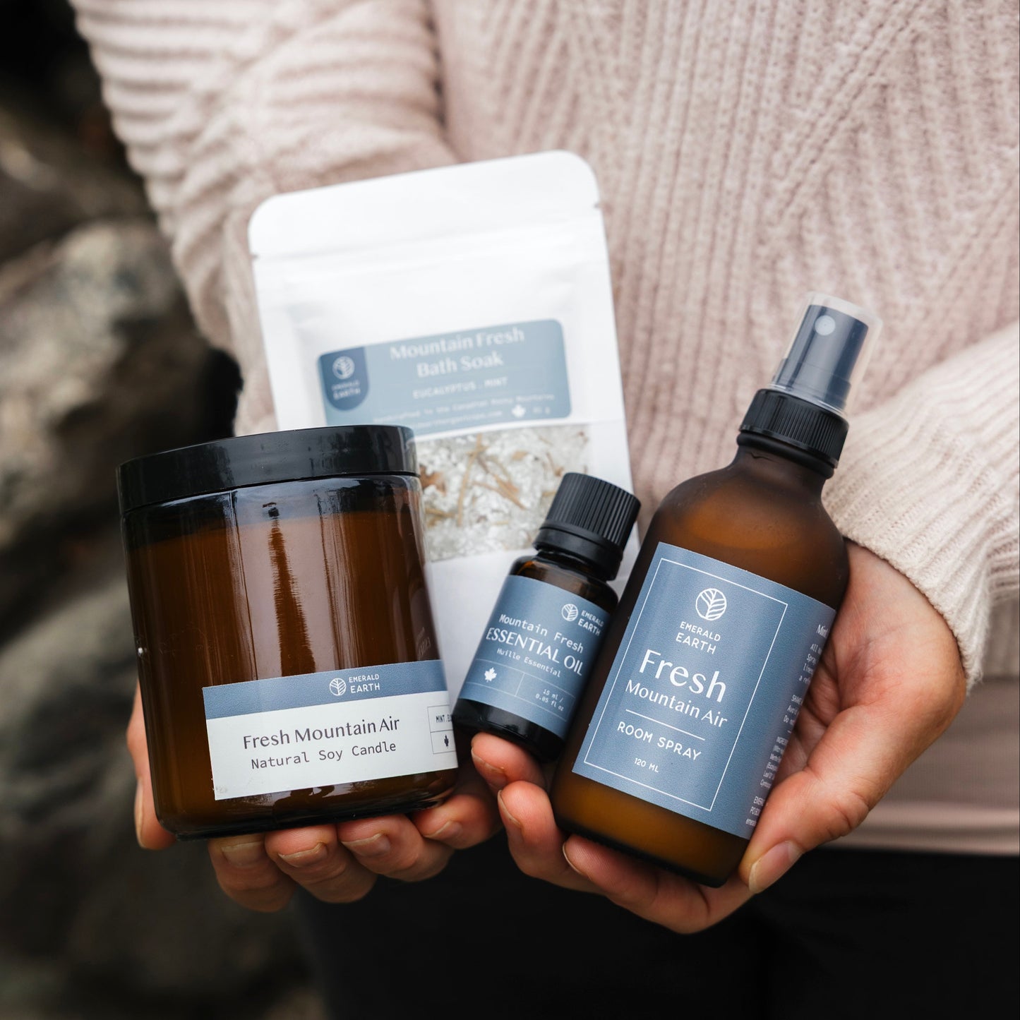 Person holding a set of 'Fresh' skincare products against a stone wall background