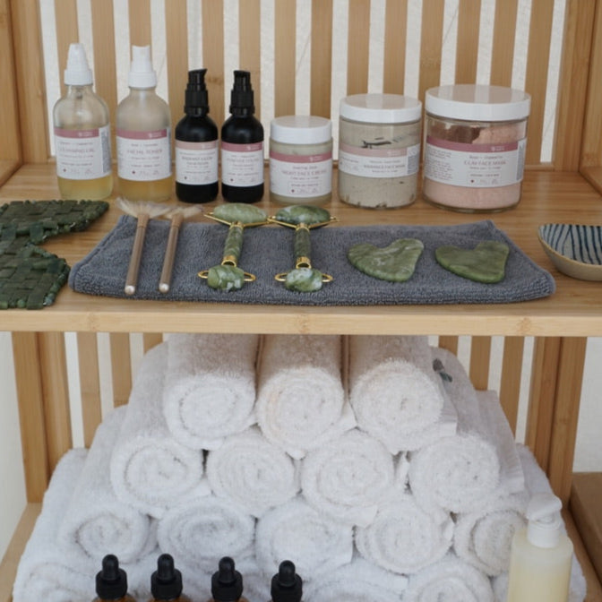 Towel tower with bottles and containers on a wooden shelf