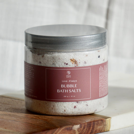Jar of bubble bath salts on a wooden board with a neutral background