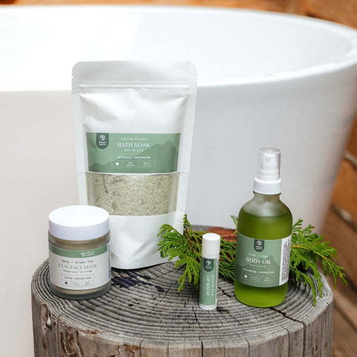Collection of natural skincare products on a wooden block with a bathtub in the background