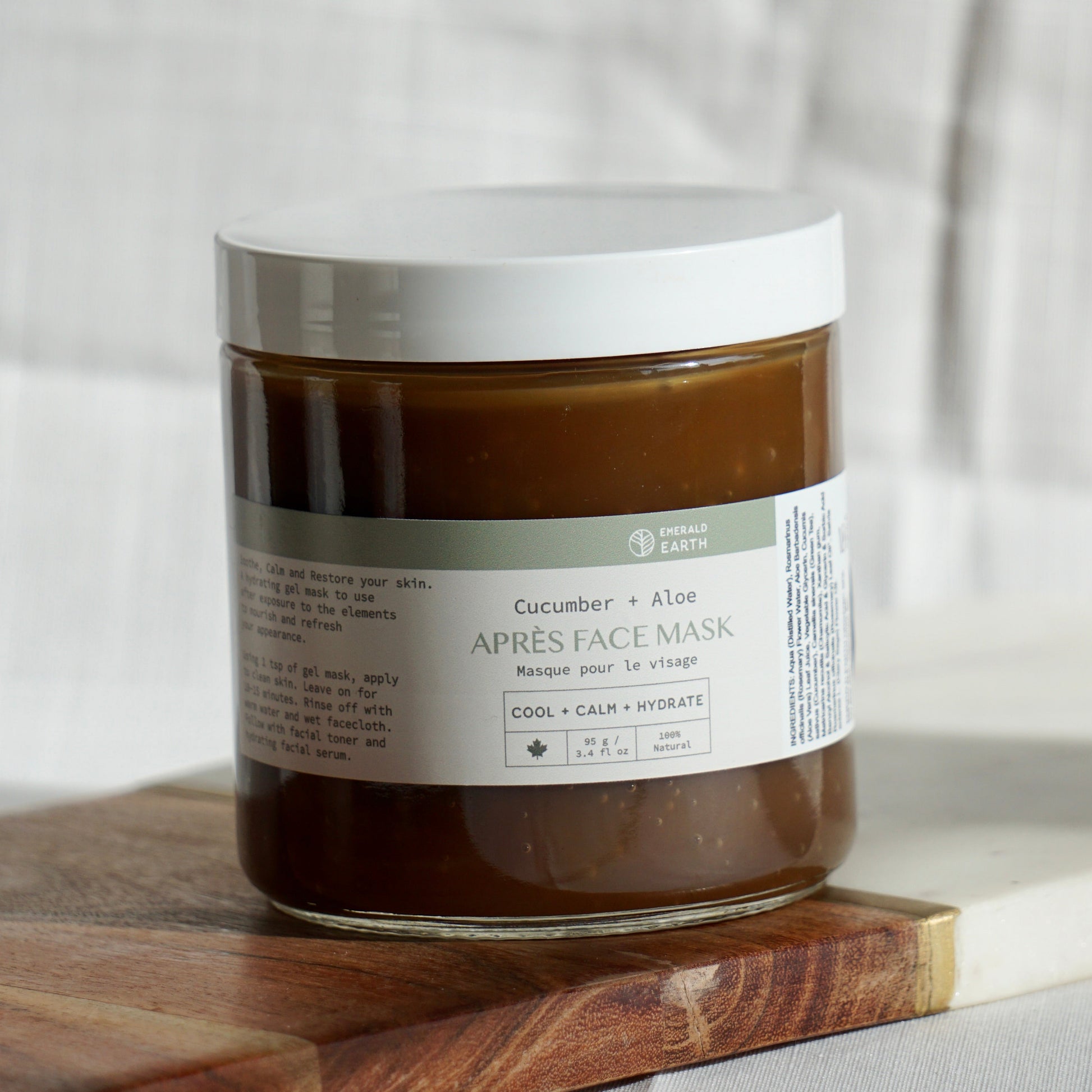 Jar of face mask on a wooden board with a neutral background