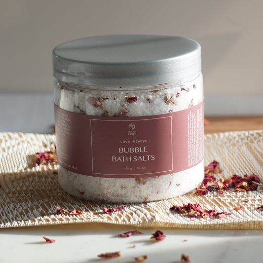 Jar of bath salts with decorative packaging on a textured surface