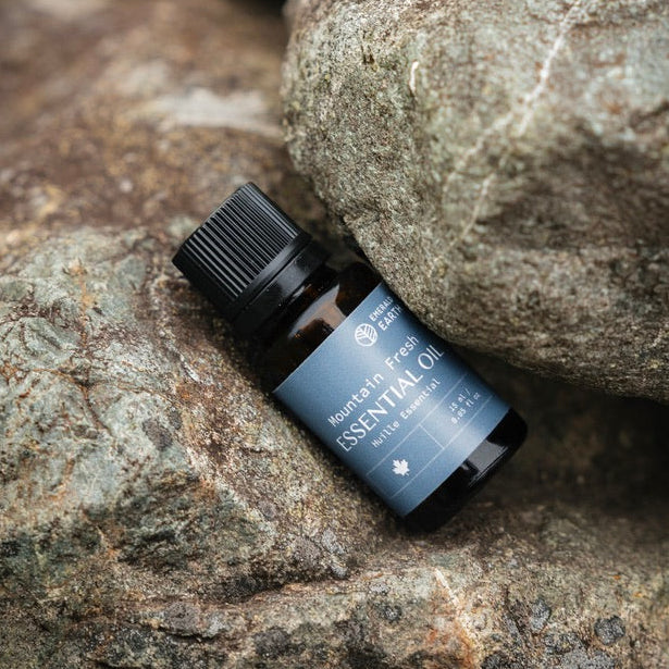 Small bottle of essential oil on a rocky surface