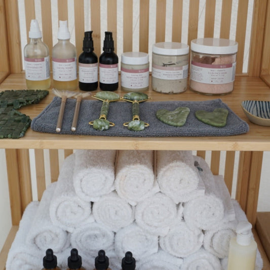 Towel tower with bottles and containers on a wooden shelf