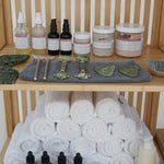 Towel tower with bottles and containers on a wooden shelf
