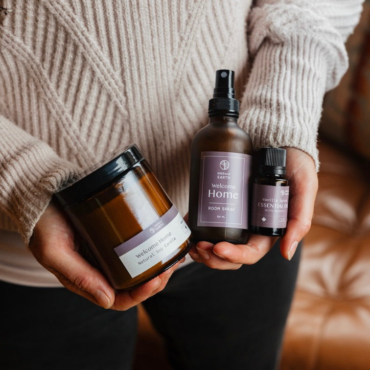 Person holding three products with visible labels against a neutral background