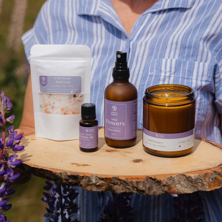 Collection of natural products including a jar, bottle, and container on a wooden surface with a blurred background.