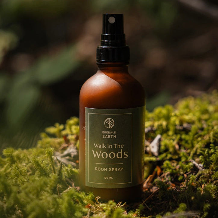 Room spray bottle labeled 'Walk in the Woods' on a mossy background